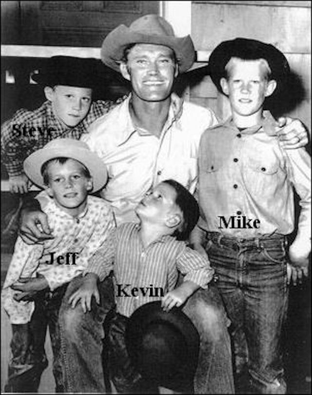 Chuck Connors with his four sons—Steve, Jeff, Kevin, and Mike—posing during a behind-the-scenes moment from The Rifleman.
